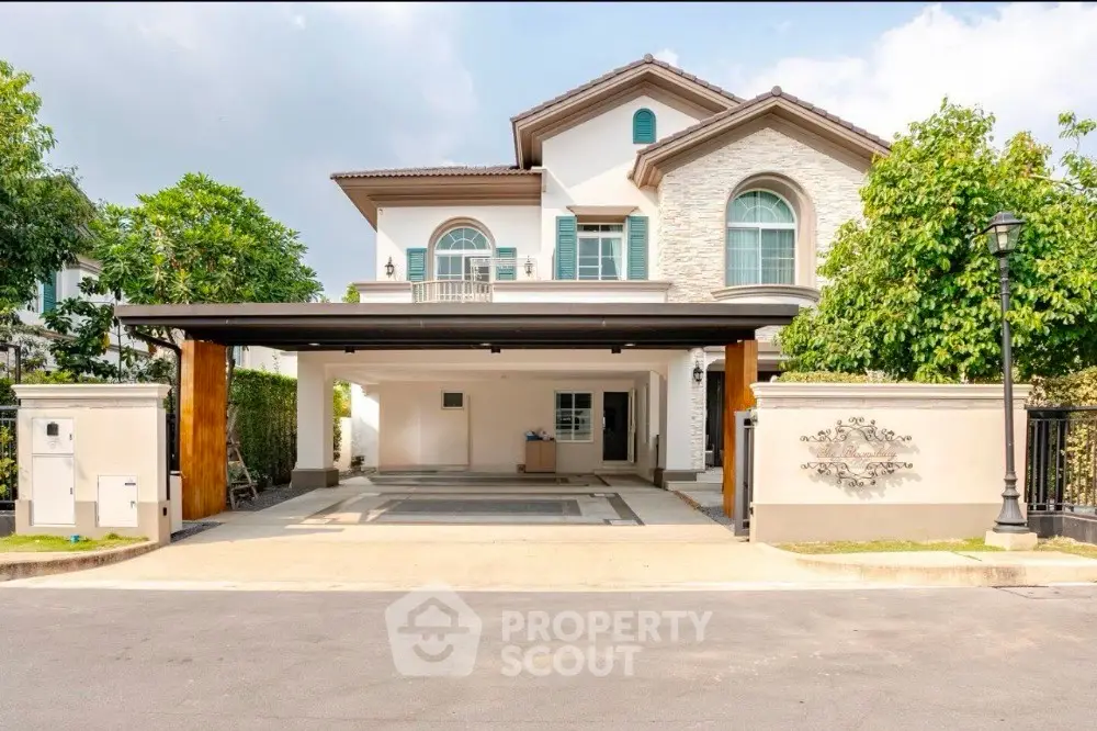 Luxurious two-story house with spacious driveway and elegant facade in a serene neighborhood.