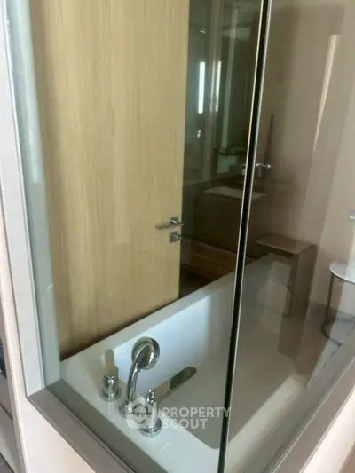 Modern bathroom with glass partition and sleek fixtures