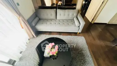 Stylish living room with modern gray sofa and elegant round coffee table