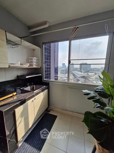 Modern kitchen with city view and sleek black countertops