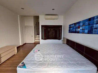 Spacious bedroom with modern decor and air conditioning