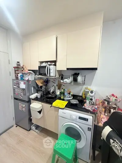 Compact kitchen with modern appliances and efficient storage solutions