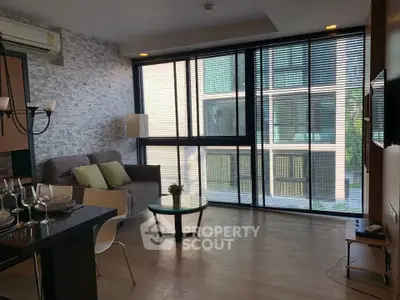 Modern living room with large windows and stylish decor in a contemporary apartment.