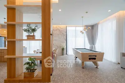 Luxurious modern living room with pool table and elegant decor, perfect for entertainment and relaxation.