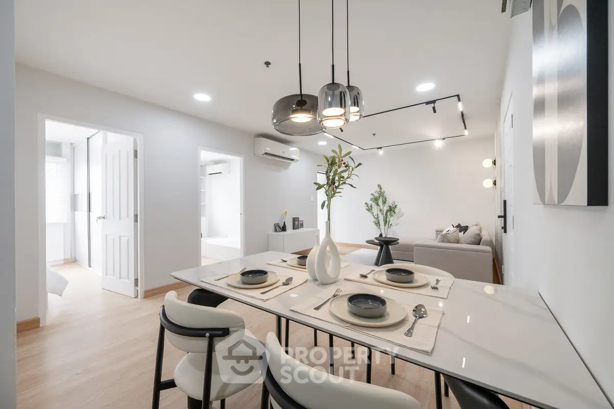 Modern open-plan living and dining area with stylish decor and natural light.
