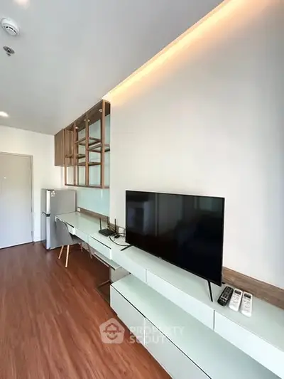 Modern living room with sleek TV setup and stylish wooden flooring