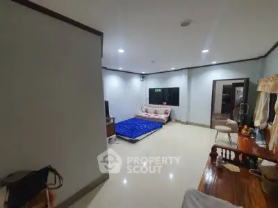 Spacious bedroom with modern decor and ample natural light