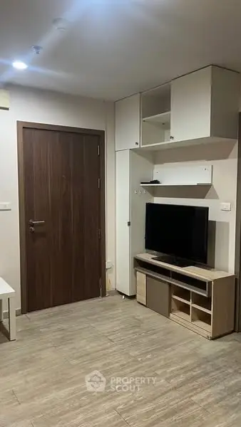 Modern living room with sleek TV unit and wooden flooring