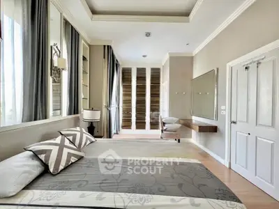 Spacious bedroom with modern decor and large windows