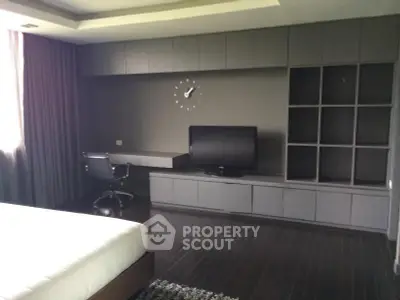 Modern bedroom with sleek built-in storage and stylish workspace
