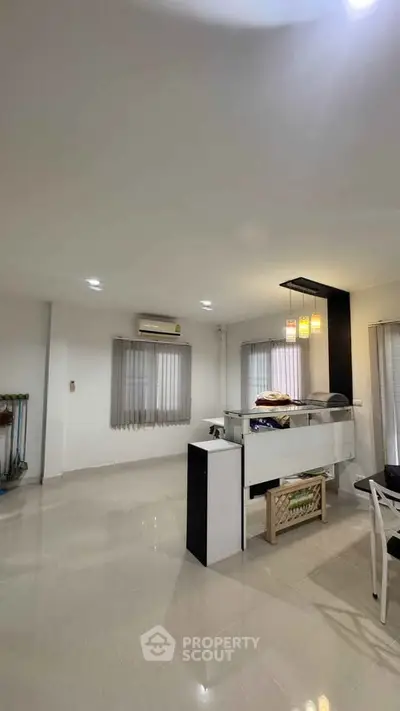 Spacious modern living room with sleek design and ample natural light, perfect for relaxation and entertainment.