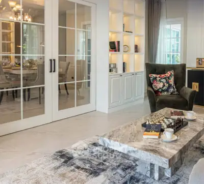 Elegant living room with marble coffee table and glass doors leading to dining area