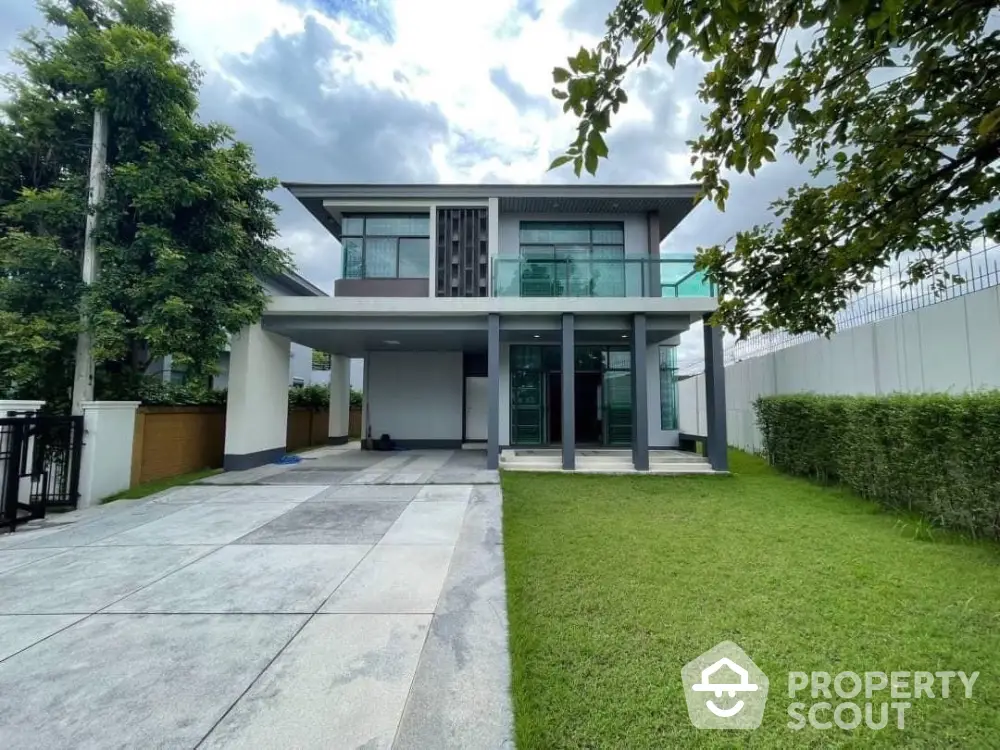 Modern two-story house with spacious driveway and lush green lawn