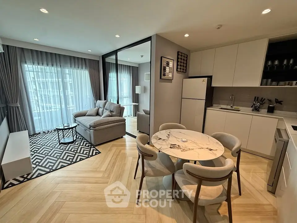 Modern open-plan living room and kitchen with stylish decor and natural light.