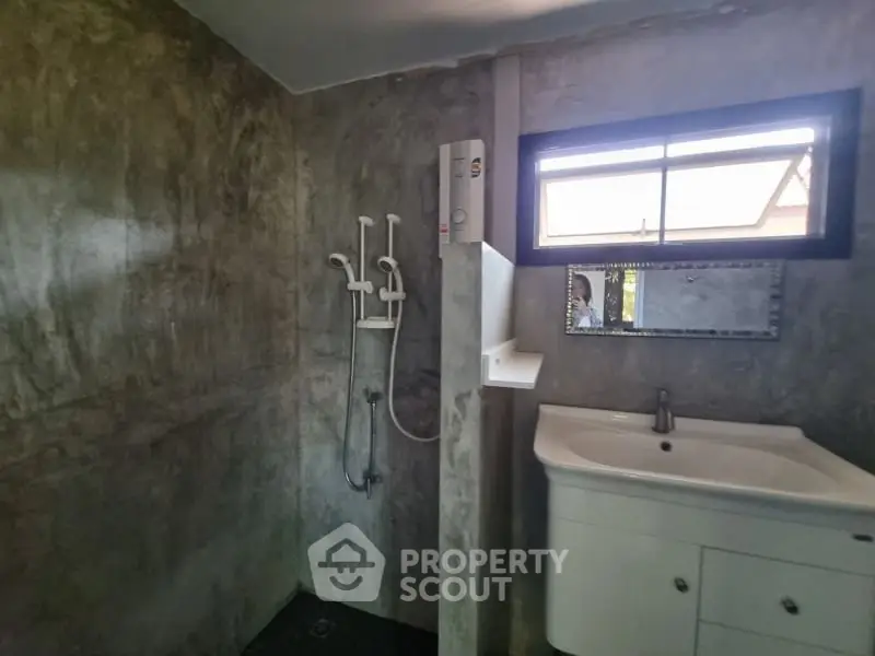 Modern bathroom with sleek concrete walls and stylish fixtures
