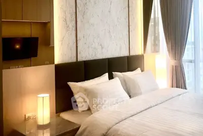 Luxurious bedroom with elegant decor and large windows offering natural light.
