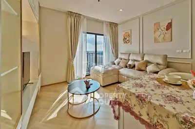 Elegant living room with cozy sofa, stylish decor, and balcony view