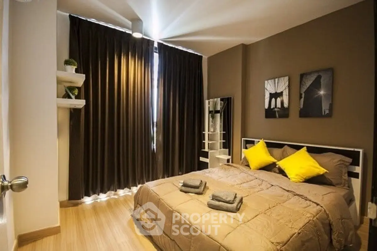 Cozy bedroom with modern decor and warm lighting, featuring a comfortable bed and stylish wall art.
