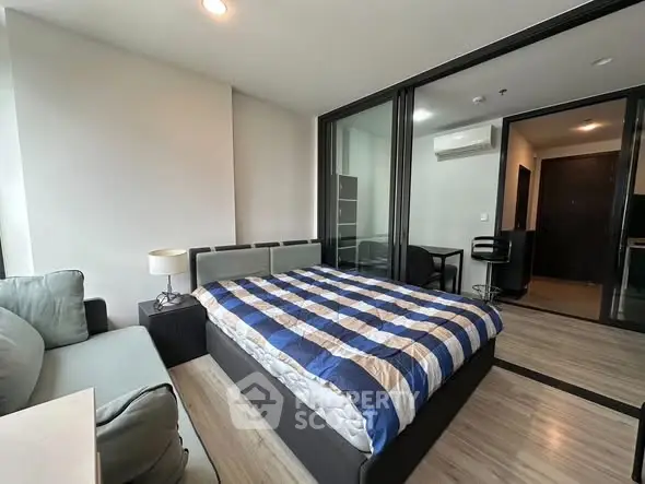 Modern bedroom with cozy bed and stylish decor in a contemporary apartment.