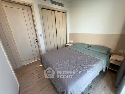 Cozy bedroom with modern design and wooden flooring, featuring a comfortable bed and ample natural light.