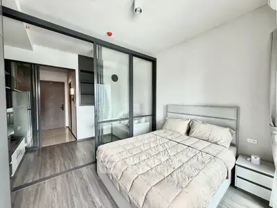 Modern bedroom with glass partition and cozy decor in a stylish apartment