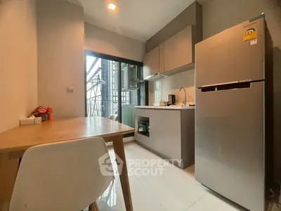 Modern kitchen with sleek appliances and dining area in a stylish apartment