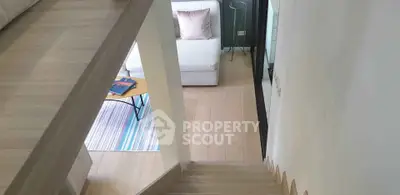 Modern living room with stylish staircase and cozy seating area
