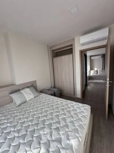 Modern bedroom with stylish decor and air conditioning in a contemporary apartment.