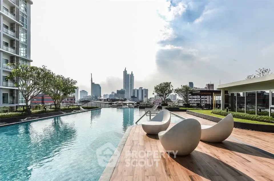 Luxurious rooftop pool with stunning city skyline view and modern seating area.