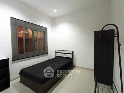 Cozy minimalist bedroom with single bed and window view
