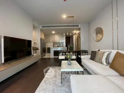 Modern living room with elegant decor and open kitchen layout in a stylish apartment.