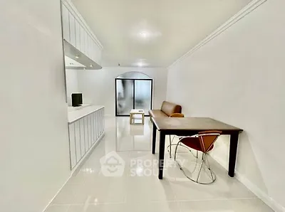 Modern minimalist living room with sleek furniture and bright white interiors.