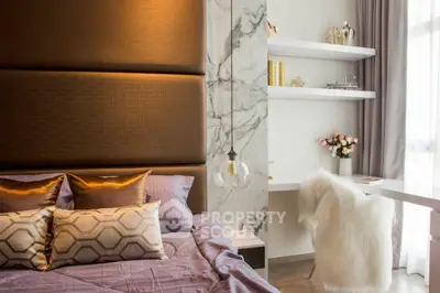 Luxurious bedroom with elegant decor and natural light, featuring plush bedding and modern furnishings.