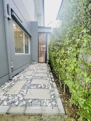 Charming garden pathway with modern landscaping and lush greenery for a serene outdoor retreat.