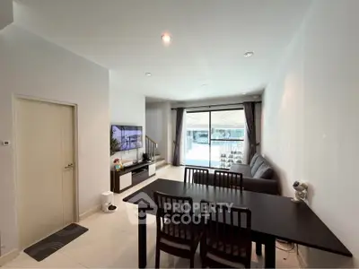 Modern living room with dining area and large window view