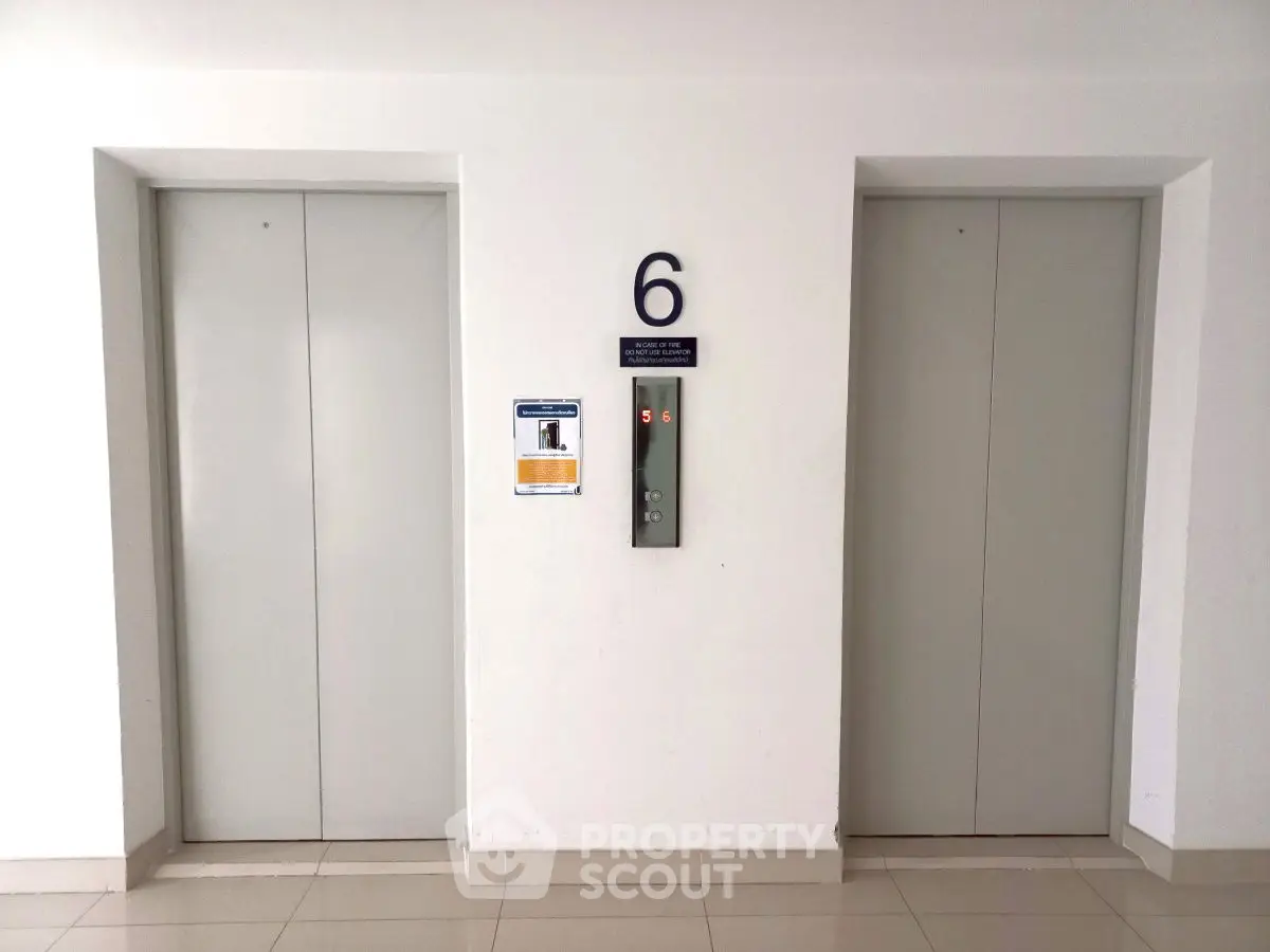 Modern building elevator lobby with two elevators on the sixth floor.