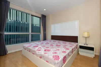 Modern bedroom with large window and stylish decor