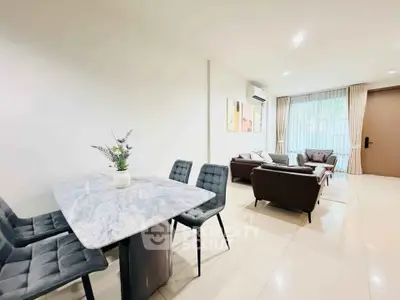 Spacious modern living room with elegant dining area and natural light
