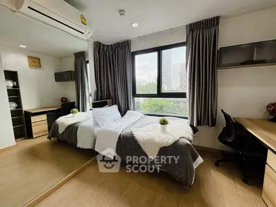 Modern bedroom with large window and stylish decor in urban apartment