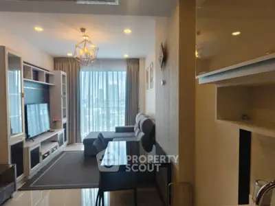 Modern living room with stylish decor and large window offering natural light.