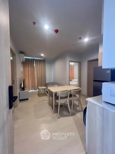 Modern apartment interior with open layout dining area and natural light