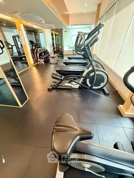 Modern gym with state-of-the-art exercise equipment and large mirrors