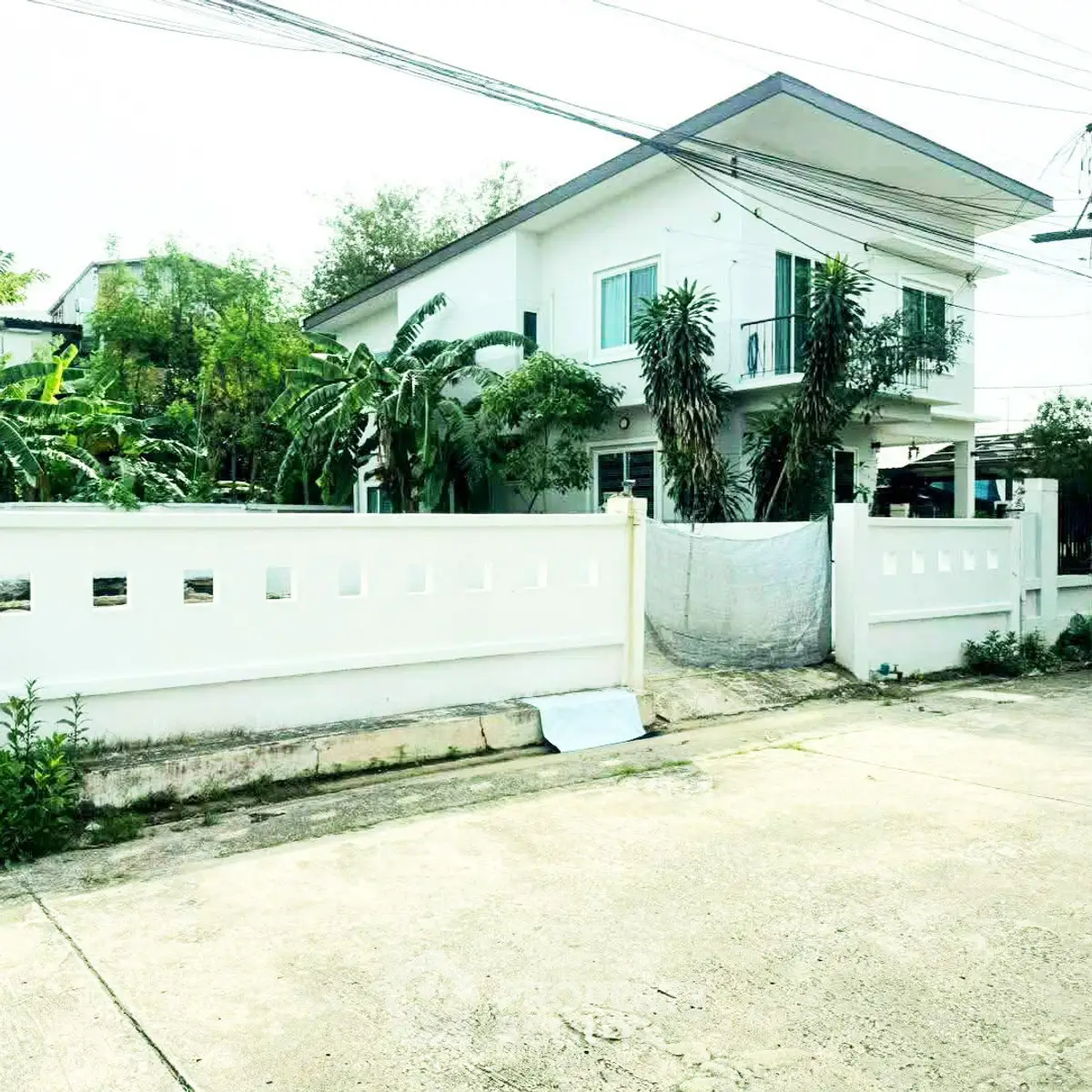 Charming two-story house with lush greenery and modern design