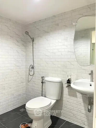 Modern bathroom with white subway tiles and sleek fixtures