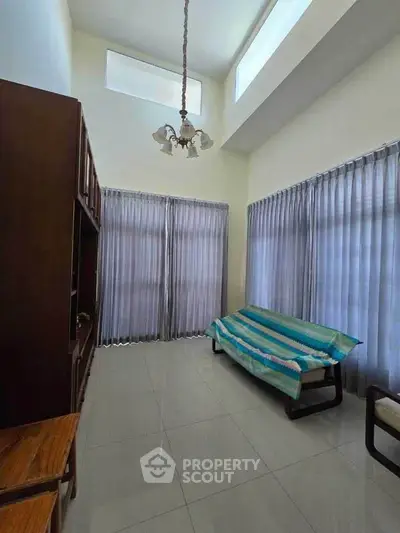 Spacious living room with high ceiling and natural light