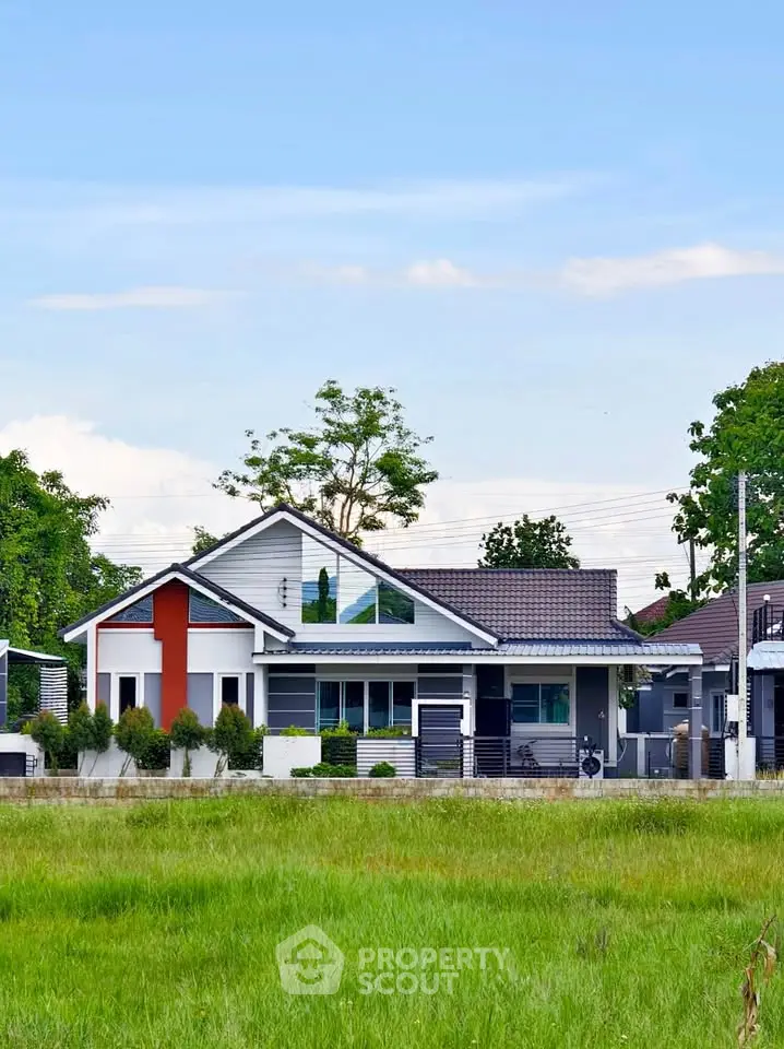 Charming modern house with lush green lawn and contemporary design in a serene neighborhood.
