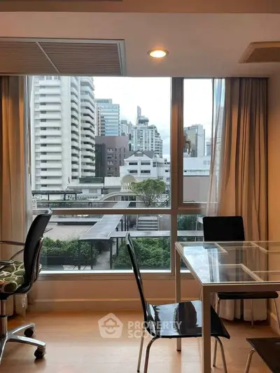 Modern apartment with city view, featuring glass dining table and sleek chairs, perfect for urban living.