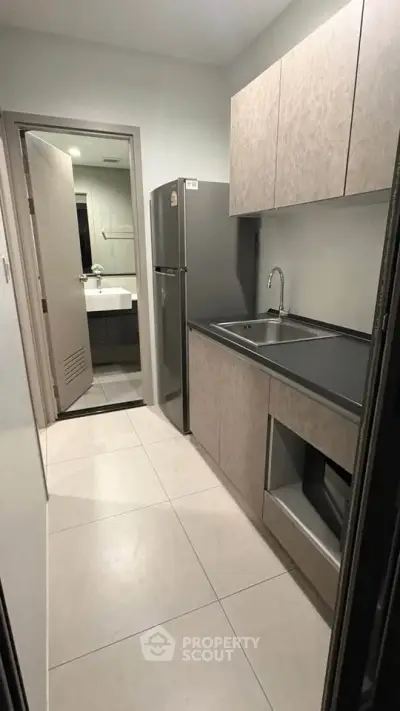 Modern compact kitchen with sleek cabinetry and stainless steel appliances