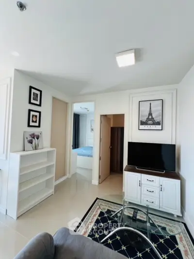 Modern living room with stylish decor and open view to bedroom