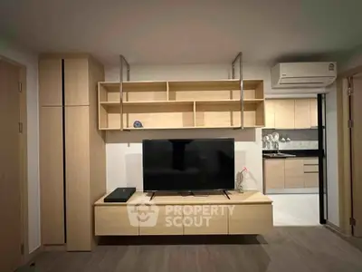 Modern living room with sleek wooden furniture and open kitchen layout